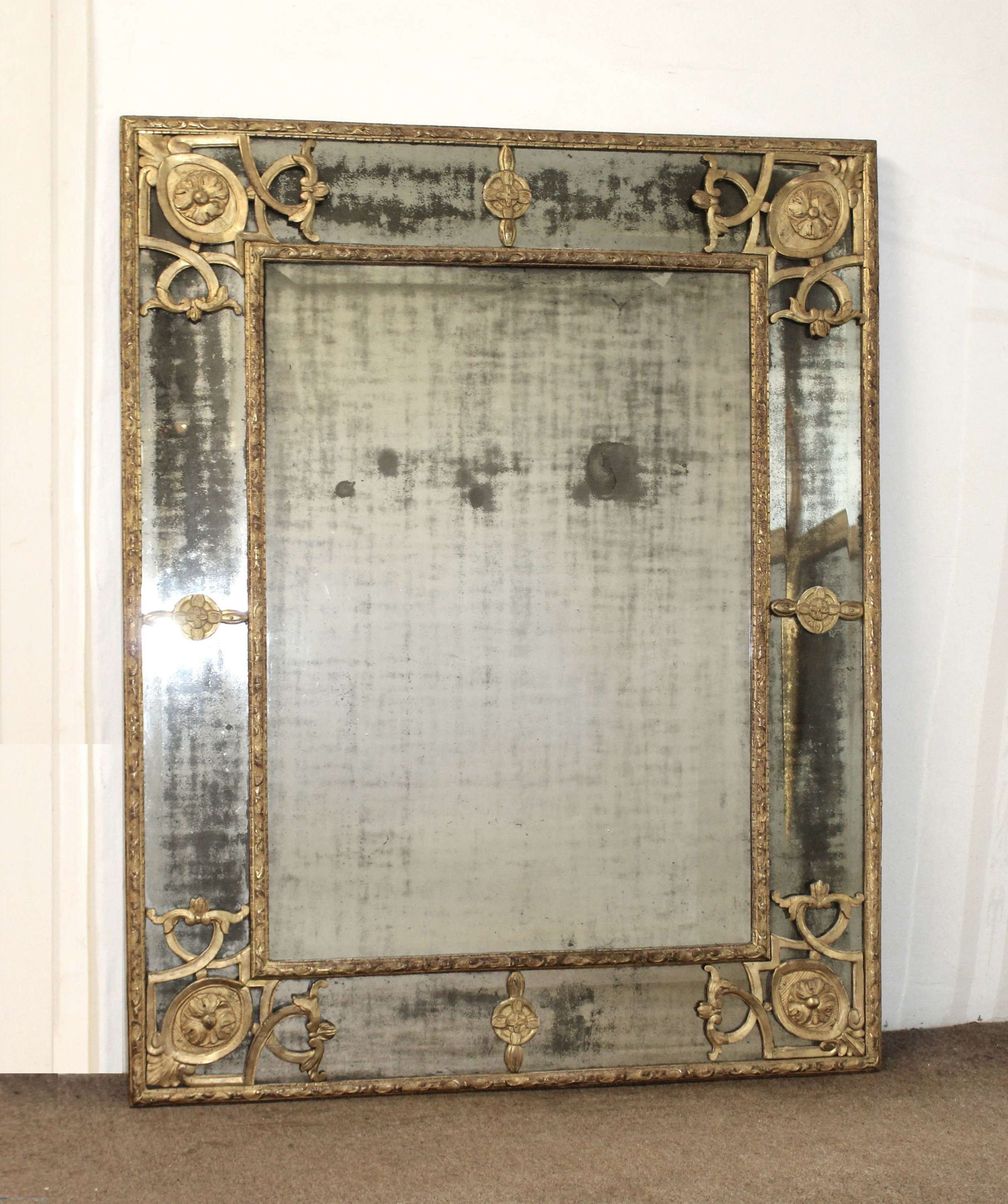Large 18th century French margin mirror with foxed mercury glass