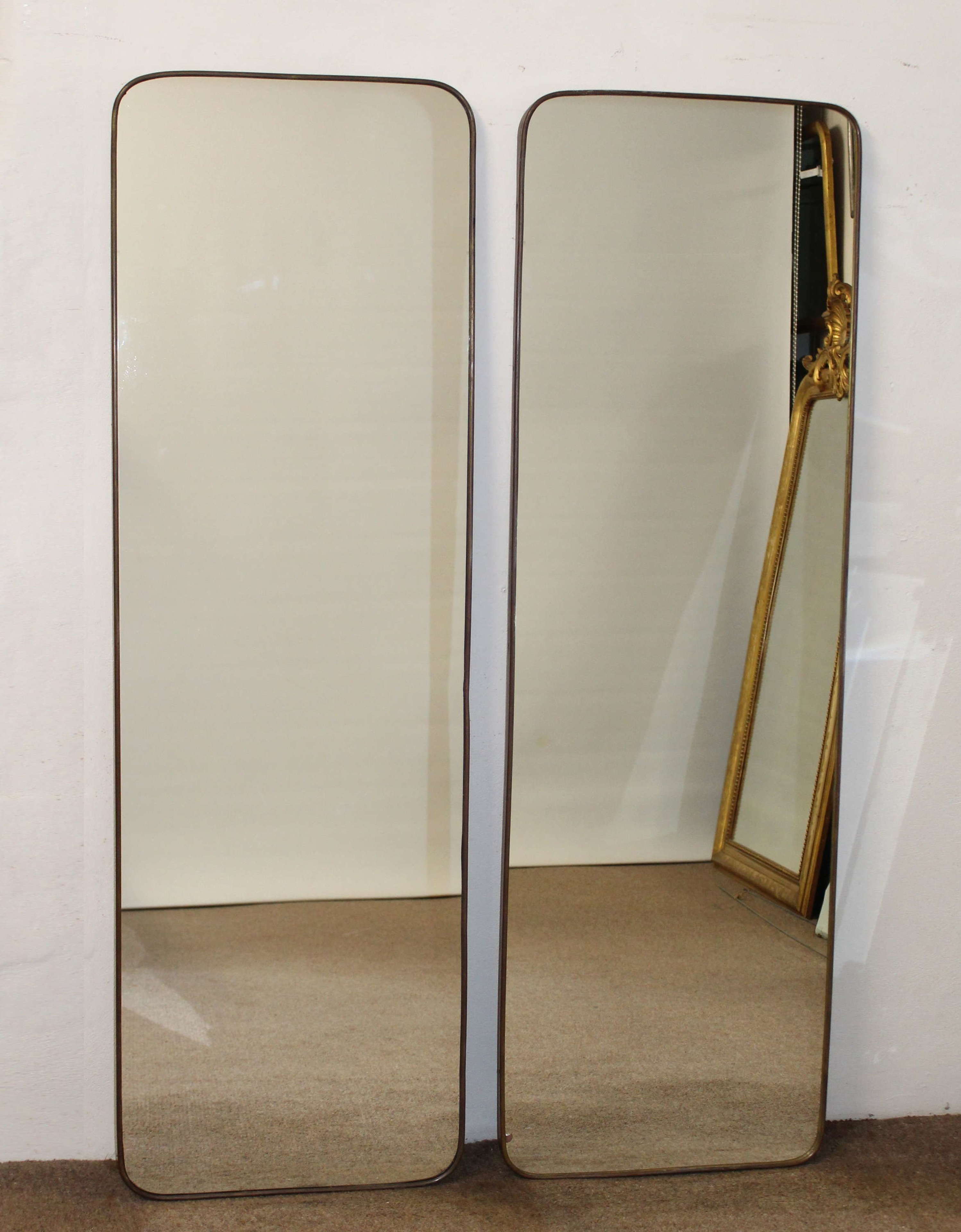 Pair of tall, narrow, brass-framed Italian mirrors
