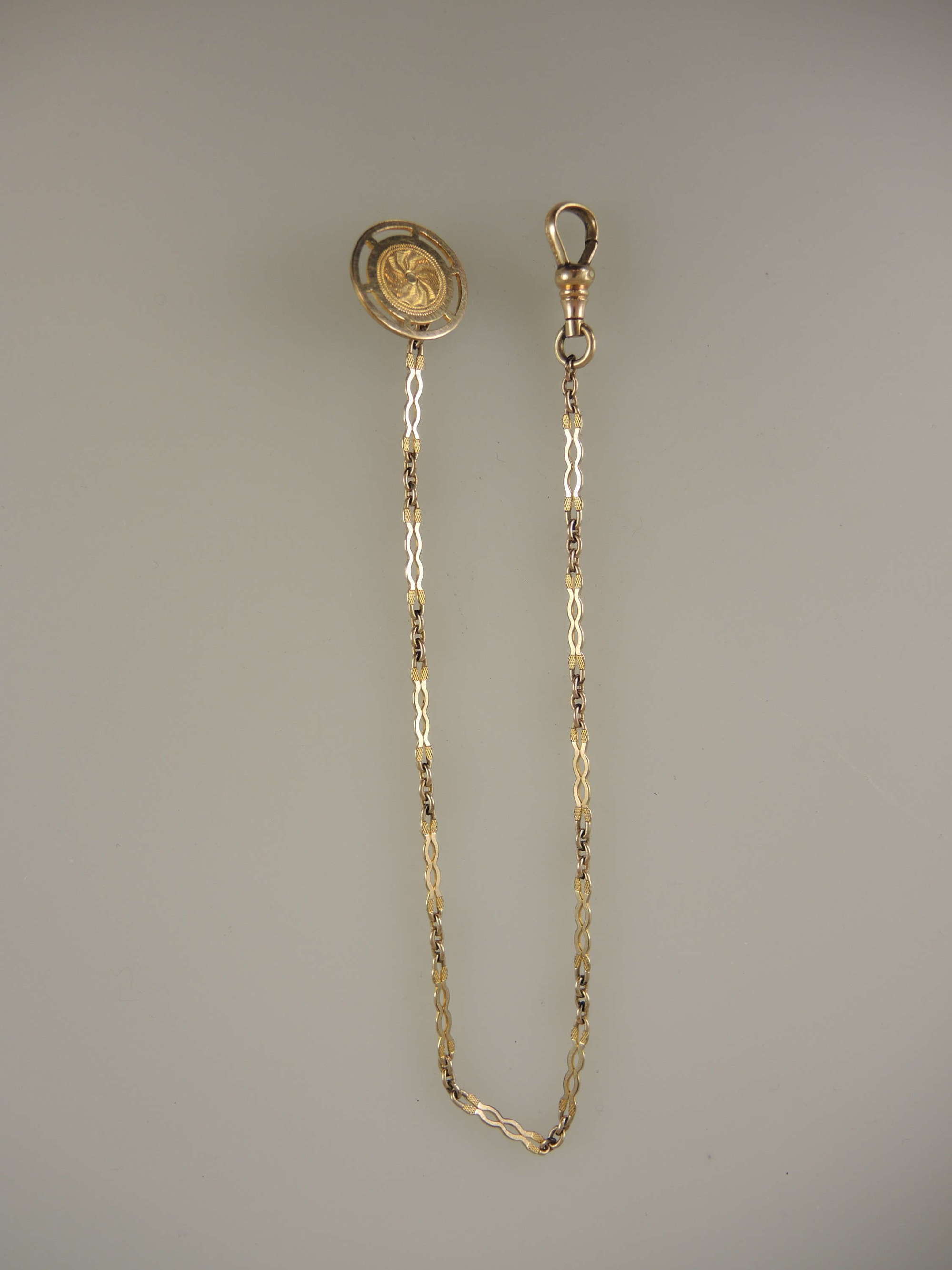 Elegant gold plated pocket watch chain for a blazer pocket c1910