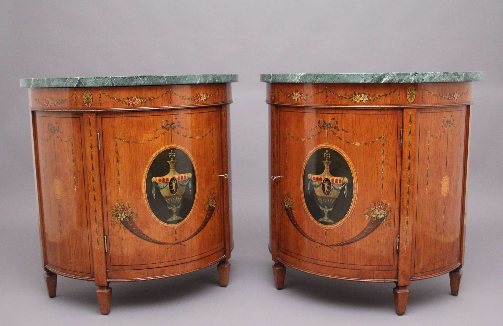 Pair Early 20thc Satinwood Demi Lune Cabinets
